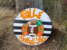 a wooden sign that says falls football yah