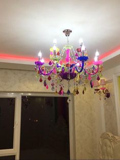 a chandelier hanging from the ceiling in a room