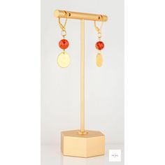 These beautiful carnelian gold disc drop earrings from Miel Jewelry Shop are a pretty addition to any outfit. The deep, vivid orange carnelian beads feature ribbons of peach and white and are paired with gold-plated circular drops. The earrings are finished with gold-plated sterling silver lever backs. They measure 1.75 inches in length. Natural variations in the stones mean your purchased item may not be exactly as the one pictured. Due to natural variations in the gemstones your purchased item Carnelian Natural Stones Dangle Earrings, Bohemian Gold Carnelian Earrings, Orange Carnelian Earrings, Orange Carnelian Round Earrings, Orange Carnelian Dangle Earrings, Carnelian Earrings, Gold Disc, Artisan Rings, Carnelian Stone