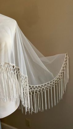 "Off-white Wedding capelet Boho vibe with a deep 10\" fringe Lots of movement One size - fits most! Front length 23\" Back length 33\"" White Bohemian Shawl With Tassels, Bohemian White Shawl With Tassels, White Bohemian Shawl With Fringe, Bohemian White Shawl With Fringe, Fitted Bohemian Shawl For Wedding, Elegant Fringe Shawl For Wedding, Elegant Fringed Shawl For Wedding, Bohemian White Shawl Cape, Elegant One Size Fringe Shawl