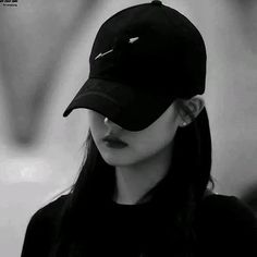 black and white photograph of a woman wearing a baseball cap