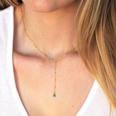 "Our lariat necklace is perfect minimalist jewelry. This dainty necklace is perfect with your favorite tee or your little black dress. A natural turquoise drop adorns a 14kt gold filled satellite chain.  D E T A I L S *Natural Arizona turquoise chips *2 inch drop  *Dainty satellite chain *100% 14kt gold dainty link chain  LENGTH *The standard length is normally 18\". *Model is wearing a 16\" in Photos. HOW TO PERSONALIZE *Select your choices from the drop down menu to create your custom design. Turquoise Charm Necklace With Adjustable Chain, Turquoise Charm Necklace With Delicate Chain, Bohemian Lariat Necklace With Delicate Chain As Gift, Dainty Lariat Necklace With Delicate Chain, Adjustable Green Lariat Necklace, Turquoise Lariat Necklace As A Gift, Turquoise Lariat Necklace Gift, Dainty Turquoise Necklace With Clavicle Chain, Dainty Turquoise Clavicle Chain Necklace