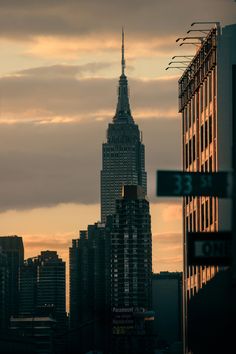 the empire building towering over new york city at sunset