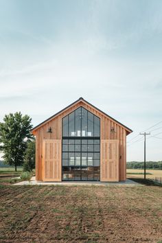 a large wooden building sitting on top of a grass covered field