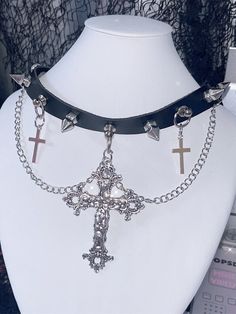 Unleash your inner rebel with our Y2K Punk Crosses Pendant Black PU Choker. Crafted from high-quality black PU, this choker combines edgy style with a touch of gothic elegance. The centerpiece features striking cross pendants that dangle effortlessly, adding a bold statement to any outfit. Adorned with silver-tone chains and studded accents, this choker exudes a punk rock vibe that's perfect for those who dare to be different. The adjustable buckle ensures a comfortable fit for all neck sizes. Goth Chain Belt, Emo Necklace, 80s Punk Fashion, Goth Grunge Outfits, 80s Punk, Gothic Elegance, Black Studs, Y2k Punk, Steampunk Fashion Male