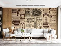 a living room filled with furniture next to a wall covered in newspaper pages and advertisements