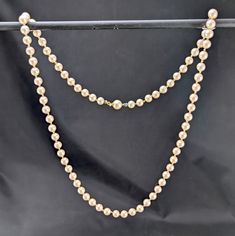 An elegant classic simulated pearl necklace. The simulated pearls are made of glass and are champagne colour. The little fastening clip does look like it has a makers mark on it, but I can't make it out properly. In good pre-owned vintage condition with the clasp working as it should. There's the odd scuff to the pearlescent coating on a few beads, but no major damage. There's discolouration to the string, more so near the clasp area. The little metal end caps have green verdigris. Length: 60 cm Classic Gold Pearl Necklace For Party, Classic Beige Jewelry For Formal Occasions, Classic Gold Pearl Necklace With 8mm Beads, Elegant Party Necklace With 8mm Beads, Classic Cream Necklace For Party, Champagne Colour, Champagne Color, Wales England, Makers Mark