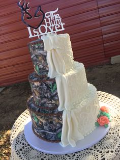 a three tiered wedding cake is decorated with camo and the words the hunt is over