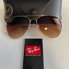 Currently One Of The Most Iconic Sunglass Models In The World, Ray-Ban Aviator Classic Sunglasses Were Originally Designed For U.S. Aviators In 1937. Aviator Classic Sunglasses Are A Timeless Model That Combines Great Aviator Styling With Exceptional Quality, Performance And Comfort. Hinge To Hinge 137mm Lens Height 50.1mm Bridge Width 58 14mm Temple Length 135mm Lenses Color Brown Gold Aviator Sunglasses With Uva Protection, Gold Aviator Sunglasses With Glass For Beach, Gold Aviator Sunglasses With Glass Lenses For Beach, Classic Glass Aviator Sunglasses For The Beach, Classic Glass Aviator Sunglasses For Beach, Classic Aviator Sunglasses For The Beach, Gold Glass Aviator Sunglasses For Beach, Model Sunglasses, Ray Ban Aviator