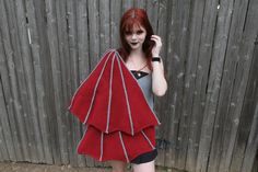 a woman with red hair wearing a knitted shawl