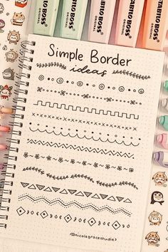 a notebook with some writing on it next to markers and pencils that say simple border