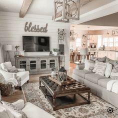 a living room filled with furniture and a flat screen tv mounted to the side of a wall