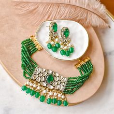 A celebratory set for those who wants a little extra glam! Beautiful piece exuding charm and elegance with hues of the emerald stones and beads along with moissanite polki stones and pearl moti embellishments. The set includes a necklace and a pair of matching earrings. Gold-plated on high-quality brass as base metal. Made by order. Kindly allow 4-6 weeks for the delivery of this item. For custom or urgent requests, please contact support@alacouture.com. *Please Note: We use faux stones and beads in all of our jewelry. Unique Gift Cards, Heritage Jewellery, Waist Chain, Faux Stone, Head Accessories, Emerald Stone, Base Metal, Earrings Gold, Matching Earrings