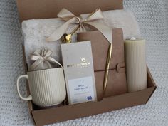 an open box containing coffee, candles and other items