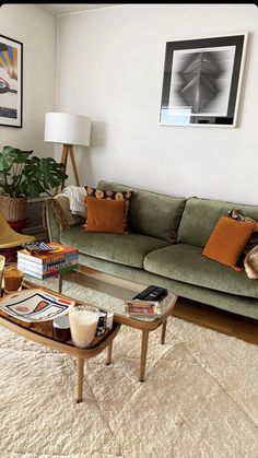 a living room filled with furniture and a coffee table in front of a painting on the wall