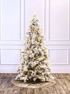 a white christmas tree on a wooden floor