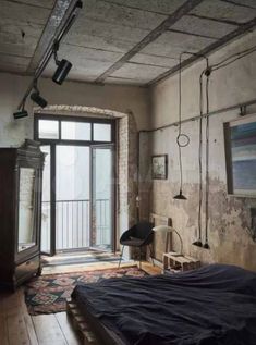 an old bedroom with exposed brick walls and wooden floors