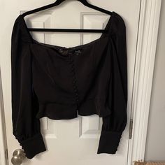 I Don’t Even Know How To Describe This Top But It Can Be Worn Off The Shoulders Or Not And The Front Has Tiny Buttons Down To The Waist And Then The Top Is Split In The Center. Top Has Large Puffy Sleeves With Beautiful Long 4” Cuffs That Have Pretty Covered Buttons. Approximate Measurements Laying Flat Are As Follows: Armpit To Armpit - 18.5”; Waist - 15.5”; Length - 17.5”. Never Worn; Pristine Condition. Fitted Cropped Blouse For Night Out, Fitted Crop Top Blouse For Night Out, Fitted Crop Top Blouse For Date Night, Fitted Long Sleeve Crop Top For Going Out, Black Long Sleeve Crop Top For Date Night, Cropped Black Top For Date Night, Black Cropped Top For Date Night, Bardot Top, Puffy Sleeves