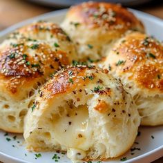 several pieces of bread on a plate with some sprinkled cheese and chives