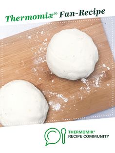 two doughnuts sitting on top of a wooden cutting board