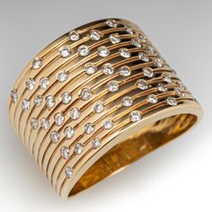 a gold ring with rows of diamonds on it