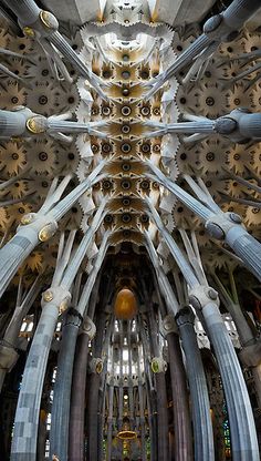 the inside of a cathedral with multiple columns and large metal pipes on each side of it