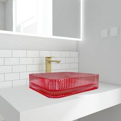 a red glass sink in a white bathroom