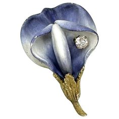 This is an extraordinary antique Old Mine Cut Diamond Enamel Flower Brooch in its Tiffany & Co. fitted box. The magnificent fully three dimensional flower represents possibly a Calla Lily or an Orchid. The polychrome enamel is exquisite with its shades of purple and lavender blue and white. The brooch is further adorned with a gorgeous sparkling white Old Mine Cut Diamond. The brooch is 14 Karat Yellow Gold. The brooch is in its fitted Tiffany & Co. leather box. The craftsmanship of the beautifully modeled flower is extraordinary. The brooch is one of the most beautiful Victorian - Art Nouveau jewels we have seen. The stunning design is timeless. The use of the enamel allowed the Tiffany jewelers to create the extraordinary life like design of the jewel which gives the brooch such romance Old Mine Cut Diamond, Leather Box, Diamond Brooch, Victorian Art, Lavender Blue, Enamel Brooch, Tiffany And Co, Enamel Flower, Gold Enamel