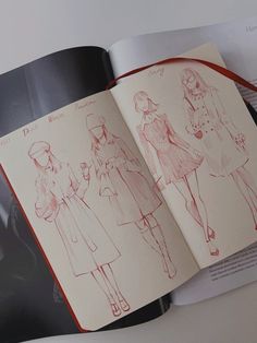 an open book with drawings of women in dresses and hats on it's pages