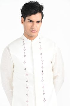 Ivory Phulkari inspired Nehru Jacket with pipe, cutdaana and thread work embroidery with same coloured kurta with embroidery detail on the chest and sleeve. this set in made in linen Satin, Paired with Ivory slim fit Pant Pajama. Color of
the actual garment may vary due to lighting conditions during the shoot.

Size Chart For Men





	
	
					Men's Size Chart
		

		
		
						
				Size Chart For Men
				Custom Size Measurement Guide
			
			
				
				
				Custom Size Measurement Guide
1. Take you Formal Nehru Jacket With Floral Embroidery And Straight Cut, Elegant Embroidered Nehru Jacket For Traditional Ceremonies, Formal Nehru Jacket With Floral Embroidery And Straight Fit, Formal Straight Nehru Jacket With Floral Embroidery, Designer Traditional Wear With Resham Embroidery In Off White, Designer Off White Traditional Wear With Resham Embroidery, Elegant Resham Embroidery Nehru Jacket For Traditional Ceremonies, Elegant Nehru Jacket With Resham Embroidery For Ceremonies, Traditional White Embroidered Fabric For Formal Occasions