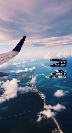 an airplane wing flying over the ocean with a poem written on it's side