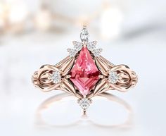 a pink diamond ring with white diamonds on it