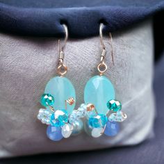 Beautiful handmade butterfly design earrings, aquamarine colour, made by our Fair Trade partners in Thailand. Earrings are approx. 4 cms long including sterling silver hooks by 1 cm wide. Please also visit my new shop, BALI COCONUT BY ROSA made in Fairtrade partnership with fine Balinese artisans and featuring all natural jewellery: https://www.etsy.com/uk/shop/BaliCoconutbyRosa Spend over $35 US Dollars with us and receive FREE postage for orders to the USA. Handmade Light Blue Aquamarine Jewelry, Handmade Blue Butterfly Earrings, Handmade Blue Aquamarine Earrings, Turquoise Aquamarine Dangle Earrings, Handmade Aquamarine Dangle Earrings, Handmade Turquoise Aquamarine Earrings, Aquamarine Drop Earrings With Ear Wire, Light Blue Beaded Earrings For Gift, Light Blue Beaded Earrings With Ear Wire As Gift