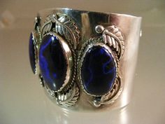 "An absolutely outstanding vintage Southwest Cuff bracelet in Sterling Silver featuring three Museum Quality Banded Azurite Cabochons, which are more than likely from the Bisbee Mine. You know you have exceptional stones in jewelry when the smith adds the carat weight on the interior of the piece, and that is what we have here; marked 65cts, etched into the interior of the bracelet. The center Azurite measures 28mm x 18.5mm. The side stones measure 25mm x 15mm and 23mm x 15mm. I have photographe Blue Oval Vintage Cuff Bracelet, Vintage Cabochon Cuff Bangle, Vintage Blue Cuff Jewelry, Navajo Art, The Smith, Three Stone, Vintage Signs, Cuff Bracelet, Class Ring