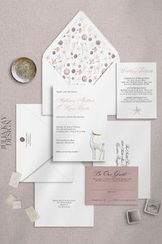 the wedding stationery is laid out and ready to be put into their guests'envelopes