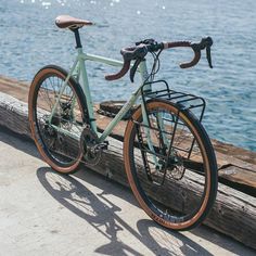 a bicycle parked on the side of a wooden pier