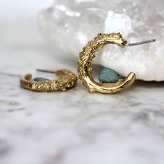 Raw apatite dipped in 18k gold. These earrings measure 1" Nature is a strong force flowing through our jewelry. We let the raw gemstones do the talking.  Each unique stone determines the shape and style each design will take on. In return, we achieve an organic and luxe feel. All of our jewelry is one of a kind. ::The process of gold dipping:: Handpicked stones are arranged and set in copper. A generous layer of 18k gold is then applied.  ♥ Thank you for shopping Cocolina ♥ Gold Agate Jewelry With Raw Stone, Raw Gemstone Earrings, Nature-inspired Gold Jewelry With Raw Stone, Gold Electroformed Hoop Earrings, Gold Electroformed Brass Hoop Earrings, Nature-inspired Raw Stone Healing Jewelry, Nature-inspired Raw Stone Pendant Jewelry, Raw Gemstones, Gold Studs