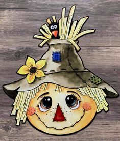 a drawing of a scarecrow wearing a hat on top of a wooden table with flowers