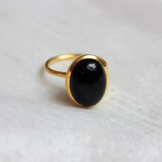 D E T A I L S - Material: 925 Sterling Silver Stone: Black Onyx Stone Shape: Square The fit: True to US ring size Finish: Smooth and gold plated to a high shine S H I P P I N G & P R O D U C T I O N - My current production time is 2-6 business days, which means after those days are up, your order ships! I make everything custom to order, by hand, but I promise you it's worth the wait! R U S H - M Y - O R D E R - If you're in a rush to get your pretty new pieces, please send me a message and Oval Onyx Rings For Anniversary, Elegant Black Oval Dome Ring, Black Dome Ring With Polished Finish As Gift, Oval Black Enamel Rings For Anniversary, Oval Onyx Cabochon Ring, Oval Cabochon Onyx Ring, Oval Onyx Ring With Cabochon, Minimalist Onyx Oval Ring, Onyx Oval Cabochon Rings For Gift