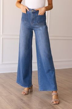 Elevate your denim game with our Medium Wash Wide Leg Flare featuring front pockets for a touch of functionality and style. Crafted from high-quality denim, these wide-leg jeans offer a flattering silhouette with a nod to retro vibes. Perfect for a casual day out or a stylish night on the town, these jeans effortlessly combine comfort and fashion-forward flair.Material & Features: Material: 70% Cotton 18% Polyester 10% Viscose 2% Spandex Stretch: Yes Zipper Fly Front and Back Patch Pockets How i Oasis Clothing, Americana Fashion, Top Graphic Tees, Sleeveless Sweater, Colored Denim, Curves Workout, Retro Vibe, Kids Bottoms, Wide Leg Jeans