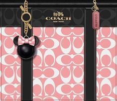 a pink and black purse with a minnie mouse keychain hanging from it's side