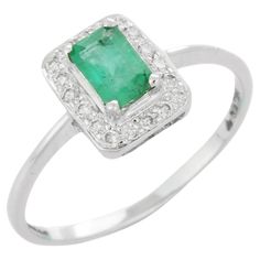 Gemstone ring in 18K Gold which perfectly goes with your personality and also helps you to improve your creativity. Designed with a emerald in center and halo of diamonds that makes it a perfect fit to wear it on your wedding or style it with any of your basic outfit to give it a glam. PRODUCT DETAILS :- > Material - 18K Solid White Gold > Gemstone - Emerald > Gemstone Weight - 0.47 ct > Gemstone pcs - 1 > Gemstone shape - Octagon > Gemstone size - 6 x 4 mm > Diamond Weight - 0.15 ct > Diamond S Gold Gemstone Ring, Emerald Gemstone, Diamond Sizes, Bridal Rings, Gemstone Ring, Ring Verlobung, Prong Setting, Diamond Engagement, Diamond Engagement Rings