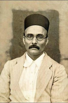 an old black and white photo of a man in a turban with glasses