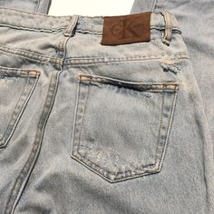 "Worn in vintage condition Distressed and faded in nicely Holes and discolorations around jeans(see photos) Ck Calvin Klein denim Size 24 on tag Please review measurements to ensure a proper fit and do not rely on the tag for sizing Waist:13.5\" Rise:10\" Inseam:26\" Hips:16\" Thigh:8\"" Acid Wash Distressed Cutoff Jeans, Classic Distressed Denim Jeans, Vintage Jeans Medium Wash With Frayed Hem, Vintage Jeans With Medium Wash And Frayed Hem, Vintage Medium Wash Jeans With Frayed Hem, Vintage Denim Jeans With Frayed Hem, Classic Distressed Faded Jeans, Classic Faded Distressed Jeans, Acid Wash Distressed Mid-rise Jeans