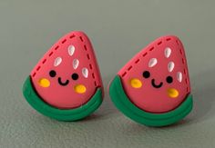 two watermelon slices with faces painted on them are sitting next to each other