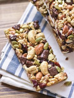 two pieces of fruit and nut bar sitting on top of a blue and white towel