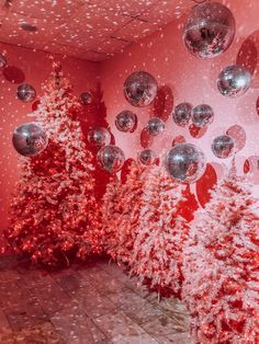 red and white christmas trees with silver balls hanging from them