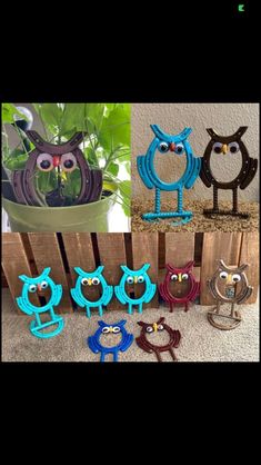 several different colored owls are sitting in front of a potted plant and one is holding scissors