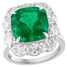 A stunning well-crafted engagement ring showcasing a 6.58-carat certified cushion-cut vivid green emerald. Flanking the center diamond are perfectly matched oval cut 10 diamonds weighing 3.05 carat in total, set in a polished platinum mounting. Handcrafted in our New York City workshop. Green Emerald is approx 11.65 x 11.40 x 8.15 mm. Style is available in different price ranges. Prices are based on your selection. Please contact us for more information. Cushion Cut Ring, Emerald Diamond Ring, American Modern, Green Emerald, Emerald Diamond, Jewelry Rings Engagement, Cushion Cut, Oval Cut, Emerald Green