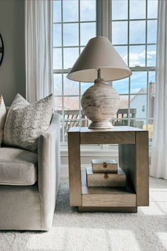 a living room scene with focus on the end table and lamp in the foreground